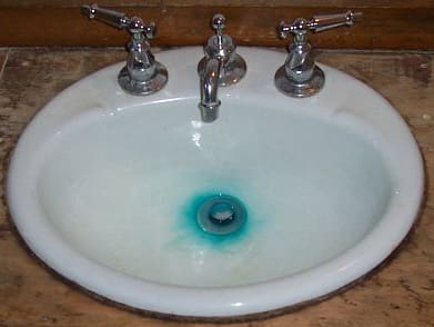 Blue green staining in bathroom sink