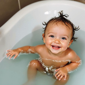 Child smiling in tub