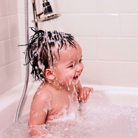 Photo of a child enjoying a shower of clean water